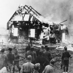 German soldiers and locals watch a Lithuanian synagogue burn on July 9, 1941. (German Federal Archive)